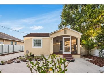 Charming home featuring a quaint screened front porch, freshly painted exterior, and driveway at 2916 W Crest Ave, Tampa, FL 33614