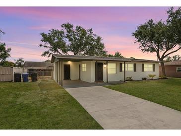 Charming single-story home with a covered carport, lush green lawn, and a welcoming driveway at 307 Francis Dr, Apollo Beach, FL 33572