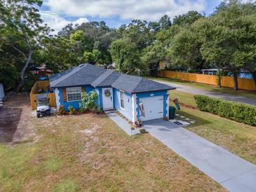 Charming, blue single-story home featuring a well-manicured lawn and welcoming curb appeal at 351 Hancock St, Dunedin, FL 34698