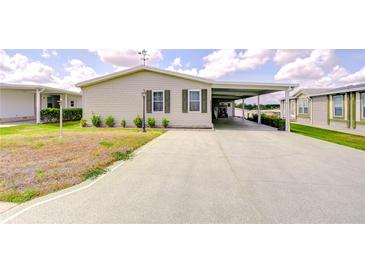 Charming single Gathering home with a spacious carport and well-maintained landscaping at 37642 Landis Ave, Zephyrhills, FL 33541