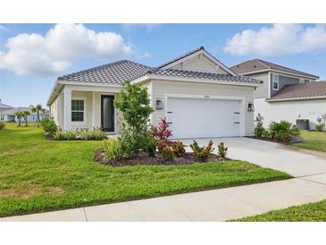 Charming one-story home featuring a well-manicured lawn and an attached two-car garage at 6281 Dry Tortugas Dr, Sarasota, FL 34241
