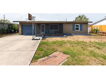 Charming single-story home with a driveway, basketball hoop and a quaint, screened front porch at 8305 75Th Pl, Seminole, FL 33777
