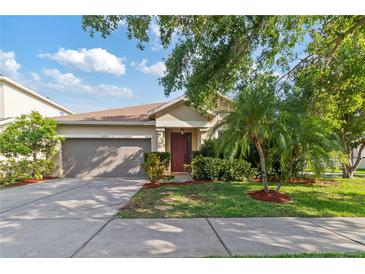 Charming one-story home with a well-maintained yard, beautiful landscaping and two-car garage at 2903 Cypress Bowl Rd, Lutz, FL 33558