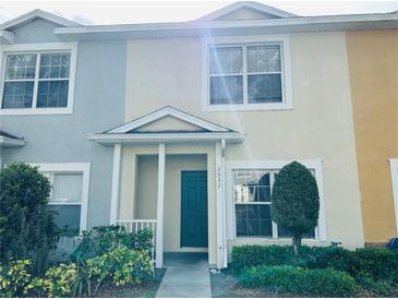 Charming townhome featuring a teal front door, well-maintained landscaping, and colorful facade at 3531 High Hampton Cir, Tampa, FL 33610