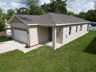 Charming single-story home featuring a one car garage and beautifully manicured lawn at 36755 Thomas Jefferson Rd, Dade City, FL 33525