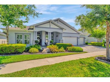 Charming one-story home with lush landscaping, manicured lawn, and a three car garage at 4093 Epic Cv, Land O Lakes, FL 34638