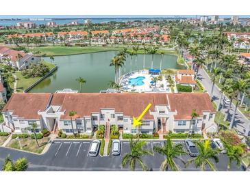A view of the condo's facade, showing the entrance, parking, and landscaping at 6100 Bahia Del Mar Cir # 105, St Petersburg, FL 33715