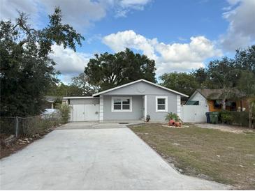 Charming single-story home with a well-maintained lawn and long driveway at 8503 N Willow Ave, Tampa, FL 33604