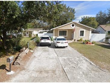 Charming single-story home featuring a well-maintained lawn, long driveway, and inviting curb appeal at 8503 N Willow Ave, Tampa, FL 33604