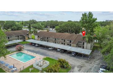 Inviting complex with a pool and convenient covered parking spaces for residents at 9821 113Th St # 201, Seminole, FL 33772