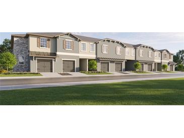 Row of new townhomes with attached garages and well-manicured front lawns at 10224 Trumpet Honeysuckle Way, San Antonio, FL 33576