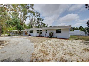 Charming single-story home with a well-maintained exterior, attractive landscaping, and a spacious driveway at 2608 Browning St, Sarasota, FL 34237