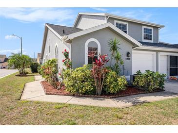 Charming two-story home featuring lush landscaping, well-maintained lawn, and a welcoming exterior at 4270 Boston Cir, New Port Richey, FL 34653