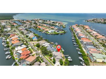 Stunning aerial view of waterfront property with boat docks and Gulf access in a beautiful coastal community at 915 Symphony Isles Blvd, Apollo Beach, FL 33572