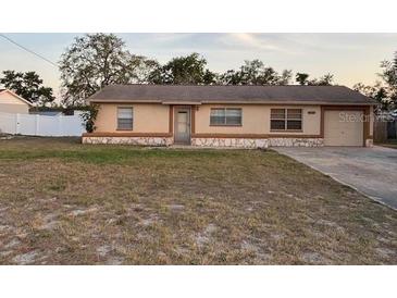 Charming single story home with a cozy, well-lit exterior, neat lawn, and inviting curb appeal at 12230 Skyler Ln, Spring Hill, FL 34609