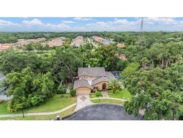 Stunning home with a sprawling lawn, mature trees, pool, and an attached two-car garage at 3013 Crest Dr, Clearwater, FL 33759