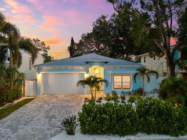 Beautiful single-story home featuring a well-manicured front yard and an attached two-car garage on a gray brick driveway at 475 Crystal Beach, Crystal Beach, FL 34681