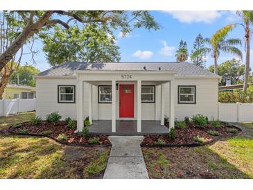 Charming home featuring a bright red front door and well-maintained landscaping at 5724 Dr Martin Luther King Jr N St, St Petersburg, FL 33703