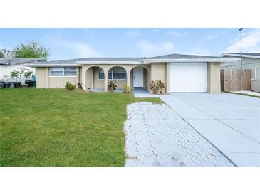 Charming home with a well-manicured lawn and inviting curb appeal at 7405 Oakshire Dr, Port Richey, FL 34668