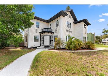 Charming two-story home with black and white accents, walkway and verdant lawn at 2306 Trelain S Dr, St Petersburg, FL 33712