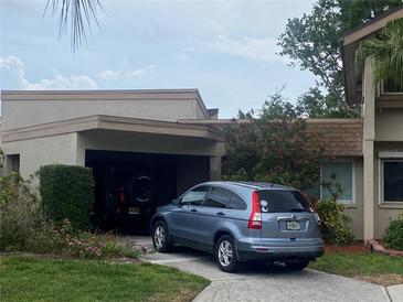 Charming home with a well-maintained lawn and a convenient attached garage at 2720 Sand Hollow Ct # 156A, Clearwater, FL 33761