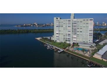 Waterfront condominium building with boat slips, a pool, and stunning views of the bay and surrounding area at 31 Island Way # 1403, Clearwater Beach, FL 33767