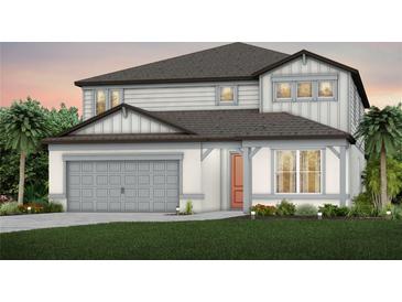 Charming two-story home with a gray garage, siding and an inviting front door at 3765 Obsidian Dr, Spring Hill, FL 34609