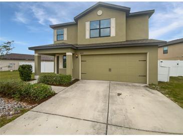 Two-story home featuring a two-car garage, neutral color scheme, and manicured landscaping for enhanced curb appeal at 8452 Silverbell Loop, Brooksville, FL 34613
