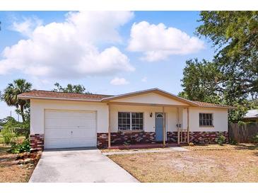 Charming single-story home with a brick facade and attached one car garage in a quiet neighborhood at 1801 Mississippi Ne Ave, St Petersburg, FL 33703