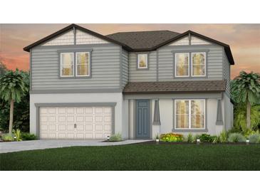 Charming two-story home featuring gray siding, a two-car garage, and beautifully landscaped front yard at 3860 Obsidian Dr, Spring Hill, FL 34609