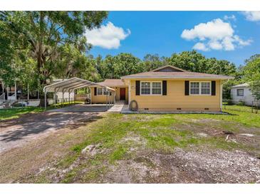 Charming single-story home with a covered carport and well-maintained front yard, exuding curb appeal at 39542 Friends Ave, Zephyrhills, FL 33540