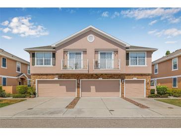 Charming townhome featuring a stone facade, balconies, and individual garages, blending style and functionality at 5176 6Th N St, St Petersburg, FL 33703