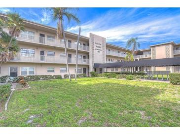 Well-maintained building exterior with neatly landscaped grounds and mature palm trees, offering a welcoming and serene environment at 1000 49Th N St # 311, St Petersburg, FL 33710