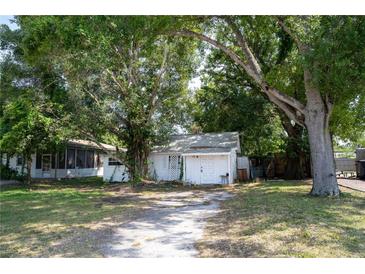 Charming single-story home with a lush, tree-filled yard and an inviting driveway at 3212 56Th N Ave, St Petersburg, FL 33714