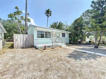 Charming single-story home with a well-manicured front yard and a quaint front porch at 627 64Th S Ave, St Petersburg, FL 33705