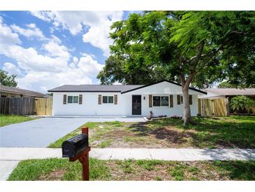 Charming renovated single-story home with new driveway and fresh landscaping and black trim at 8277 82Nd N Ave, Largo, FL 33777