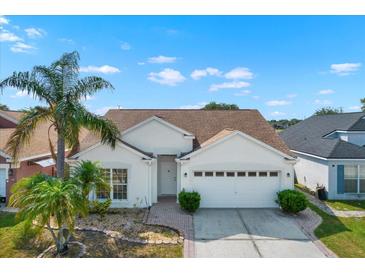 Charming single-story home with a well-manicured lawn and a two-car garage at 11307 Calgary Cir, Tampa, FL 33624