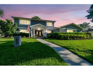 Beautiful two-story home with manicured lawn, lovely landscaping, and a charming walkway leading to the front door at 3304 Latania Dr, Tampa, FL 33618