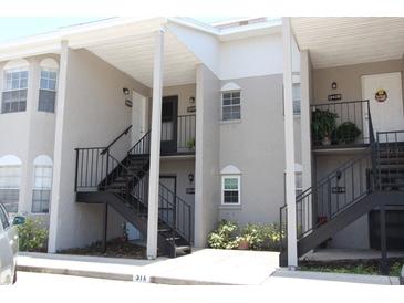 Condominium exterior featuring staircases leading to multiple units and neutral color scheme at 4513 S Oak Dr # Q31B, Tampa, FL 33611