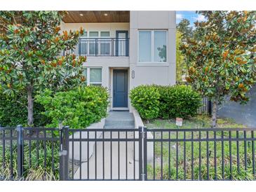 Inviting front entrance with a black metal fence, lush landscaping, and a modern facade at 4911 N Nebraska Ave, Tampa, FL 33603