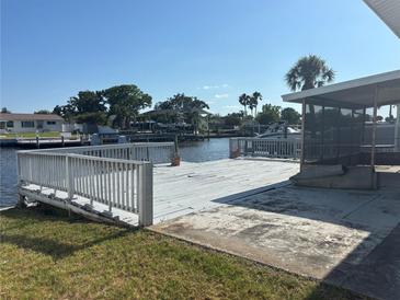 Waterfront backyard with wooden deck, offering serene views at 8422 Boxwood Dr, Tampa, FL 33615