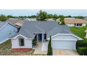 Charming single-story home with a well-maintained lawn and a new gray roof at 8913 Welsh Way, Hudson, FL 34667