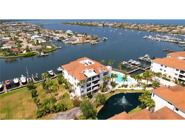 Beautiful waterfront condo with lush landscaping, community pool, and marina access at 1003 Bellasol Way # 9203, Apollo Beach, FL 33572