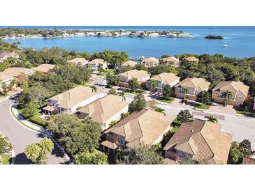 Beautiful aerial view of coastal homes featuring well-manicured lawns and stunning water views at 184 Banyan Bay Dr, St Petersburg, FL 33705