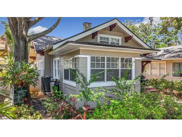 Charming craftsman home with brick foundation, complemented by lush landscaping and mature trees at 231 15Th Ne Ave, St Petersburg, FL 33704