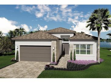 Beautiful single-Gathering home featuring a two-car garage and manicured lawn with garden beds at 32523 Neroli St, Wesley Chapel, FL 33543