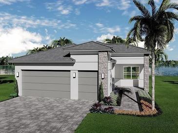 Modern home with a two-car garage, stone accents, a paved driveway, and manicured landscaping, offering waterfront views at 32608 Neroli St, Wesley Chapel, FL 33543