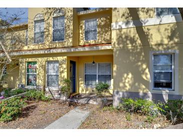 Inviting townhome features a covered porch, well-maintained landscaping, and a freshly painted facade at 3456 Castle Stone Ct, Valrico, FL 33594