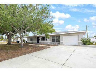 Charming single-story home featuring a well-manicured lawn, a driveway, and an attached garage at 4558 23Rd N Ave, St Petersburg, FL 33713