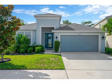 Charming single-Gathering home with a well-manicured lawn and a two-car garage in a residential neighborhood at 9059 Spruce Creek Cir, Riverview, FL 33578